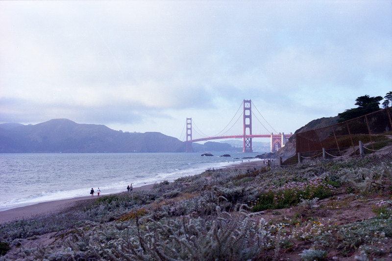 People strolling along Baker Beach, San Francisco.