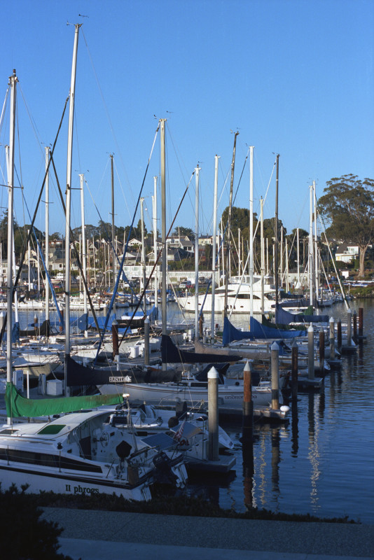 At the Santa Cruz Yacht Harbor looking toward the north; shadows moving in as night approaches. All boats appear to be secured for the evening.